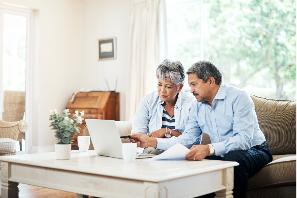 Shot of a senior couple using a laptop together at home. By shapecharge/istockphoto